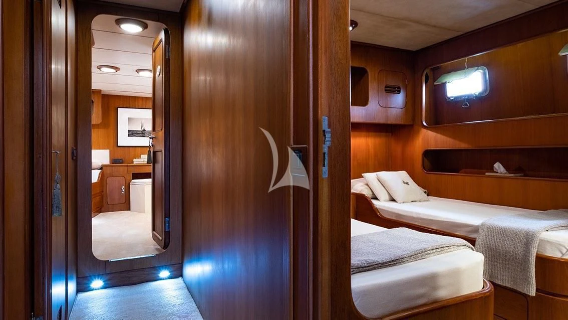 a room with a bed and a mirror aboard LOTTY Yacht for Sale
