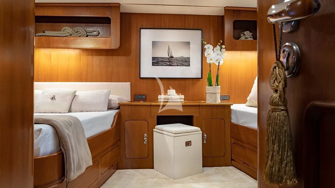 a room with a bed and a desk aboard LOTTY Yacht for Sale