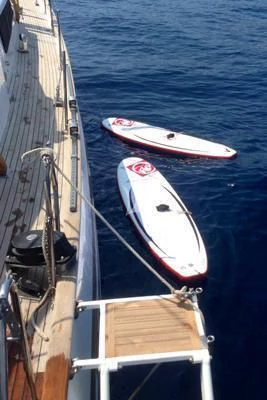 a boat with a surfboard on it aboard LOTTY Yacht for Sale