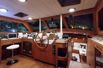 a bar with a bar and stools aboard LOTTY Yacht for Sale
