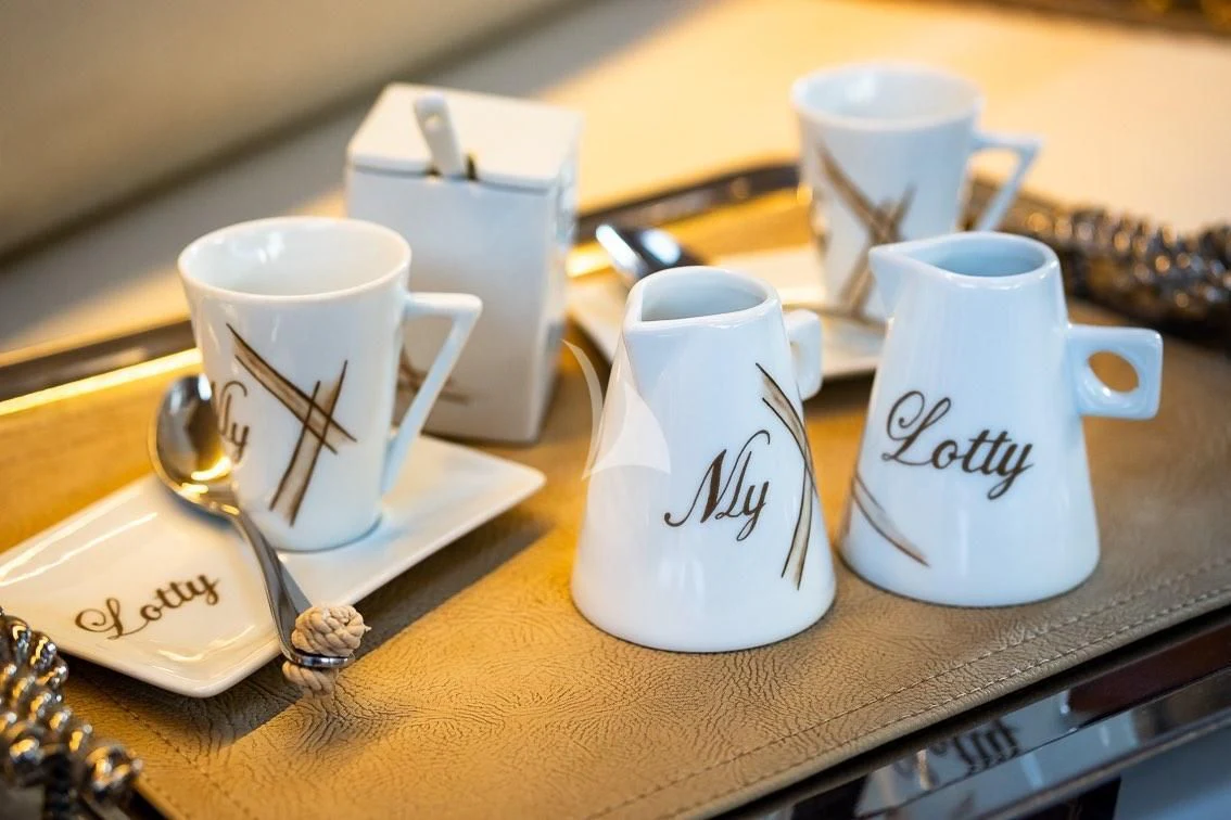 a group of coffee mugs on a table aboard LOTTY Yacht for Sale