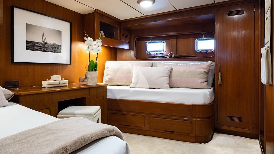 a room with a bed and a desk aboard LOTTY Yacht for Sale