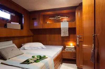 a room with a bed and a mirror aboard LOTTY Yacht for Sale