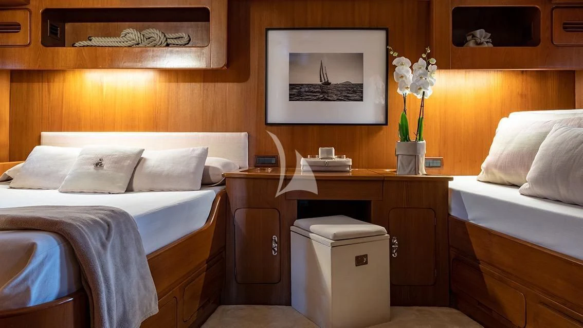 a room with a bed and a desk aboard LOTTY Yacht for Sale