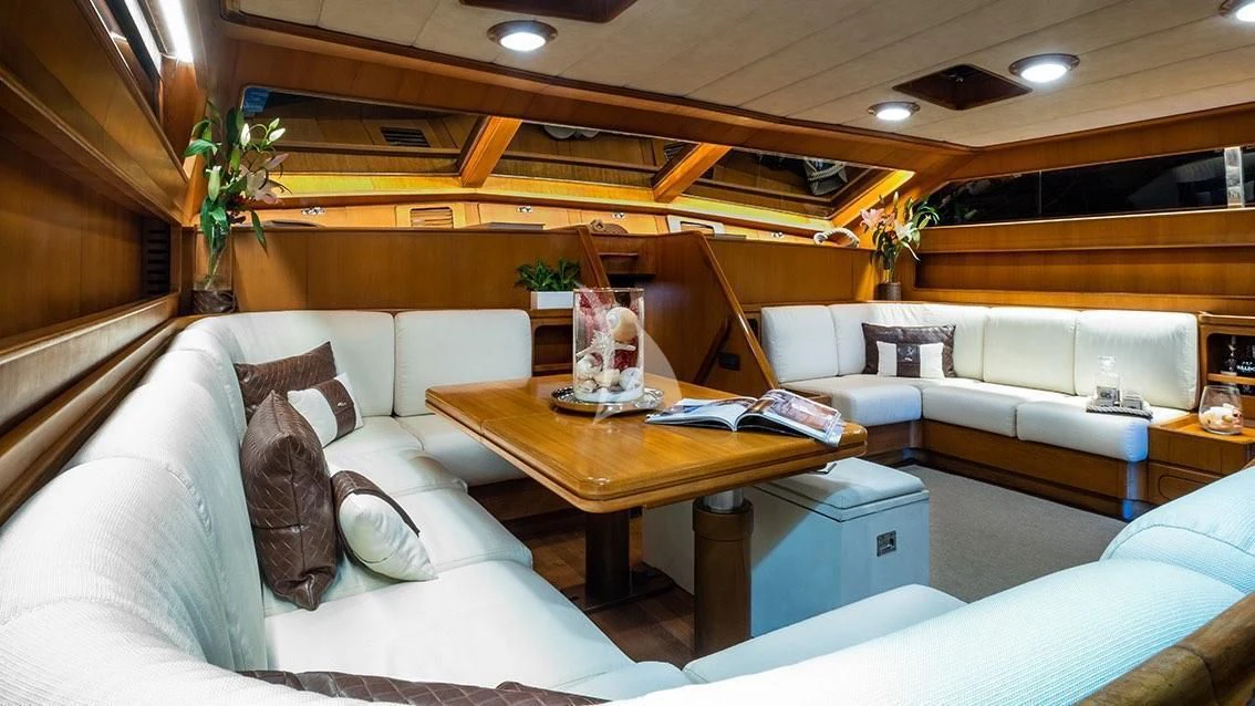 a living room with a couch and a coffee table aboard LOTTY Yacht for Sale