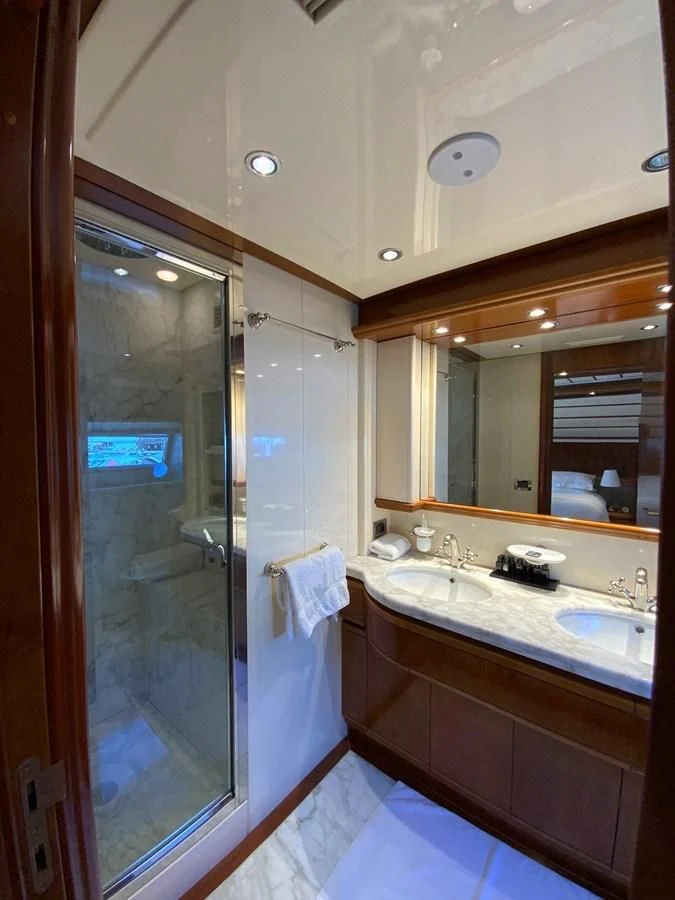a bathroom with a large mirror aboard GEMINI Yacht for Sale