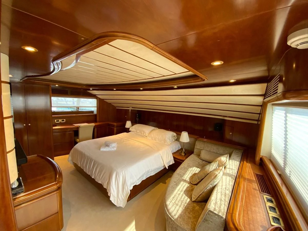 a room with a bed and a couch aboard GEMINI Yacht for Sale