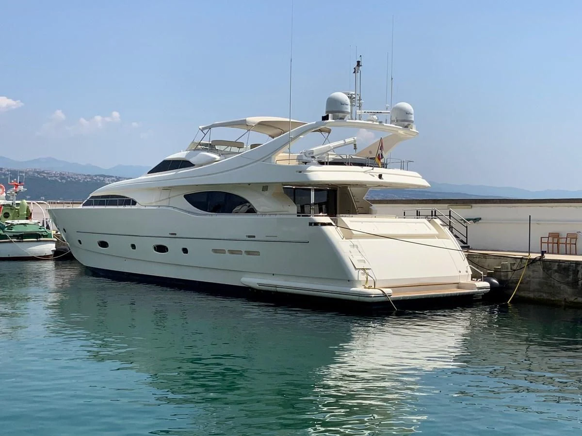 a white yacht docked at a pier aboard GEMINI Yacht for Sale