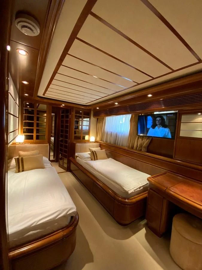 a room with a bed and a tv on the wall aboard GEMINI Yacht for Sale