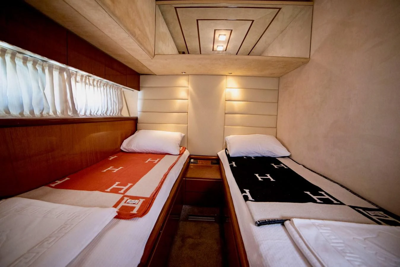 a room with beds and a window aboard FERRETTI Yacht for Sale
