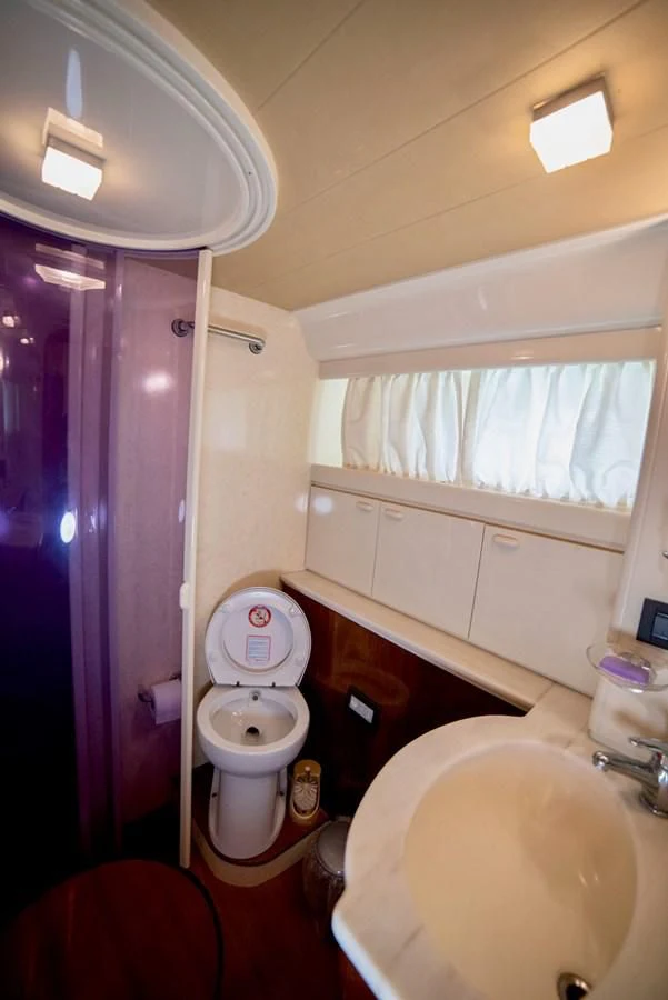 a bathroom with a toilet and a sink aboard FERRETTI Yacht for Sale