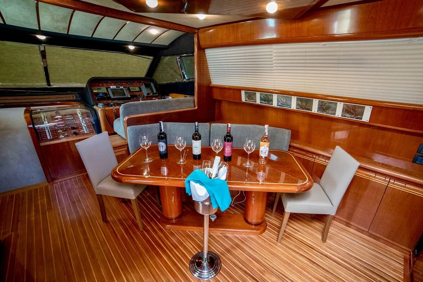 a table with wine glasses and bottles on it aboard FERRETTI Yacht for Sale
