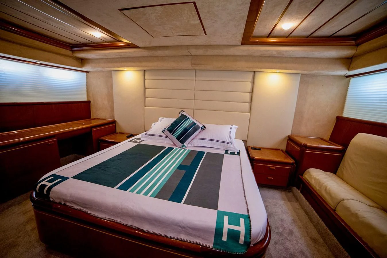 a bedroom with a bed and a couch aboard FERRETTI Yacht for Sale