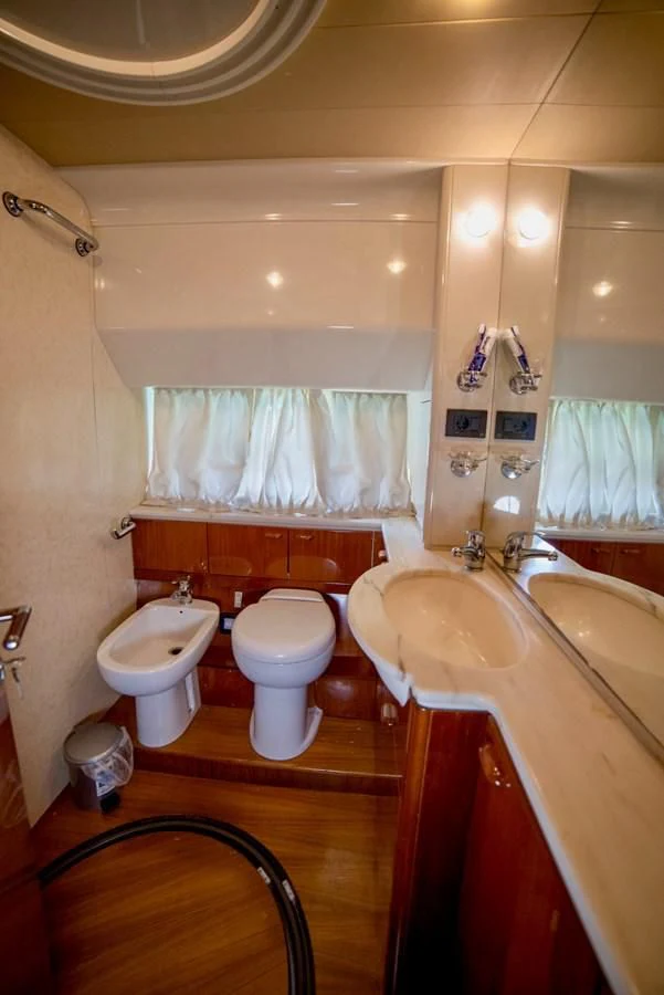 a bathroom with a tub sink and toilet aboard FERRETTI Yacht for Sale