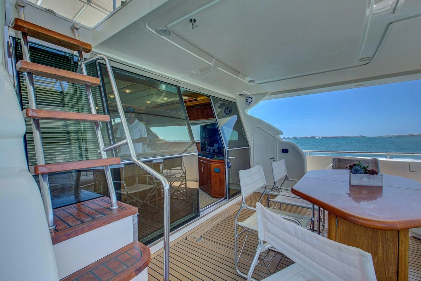 a room with a table and chairs aboard FERRETTI Yacht for Sale