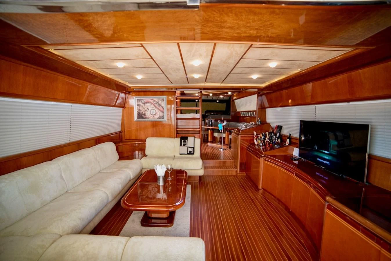 a living room with a couch and a television aboard FERRETTI Yacht for Sale