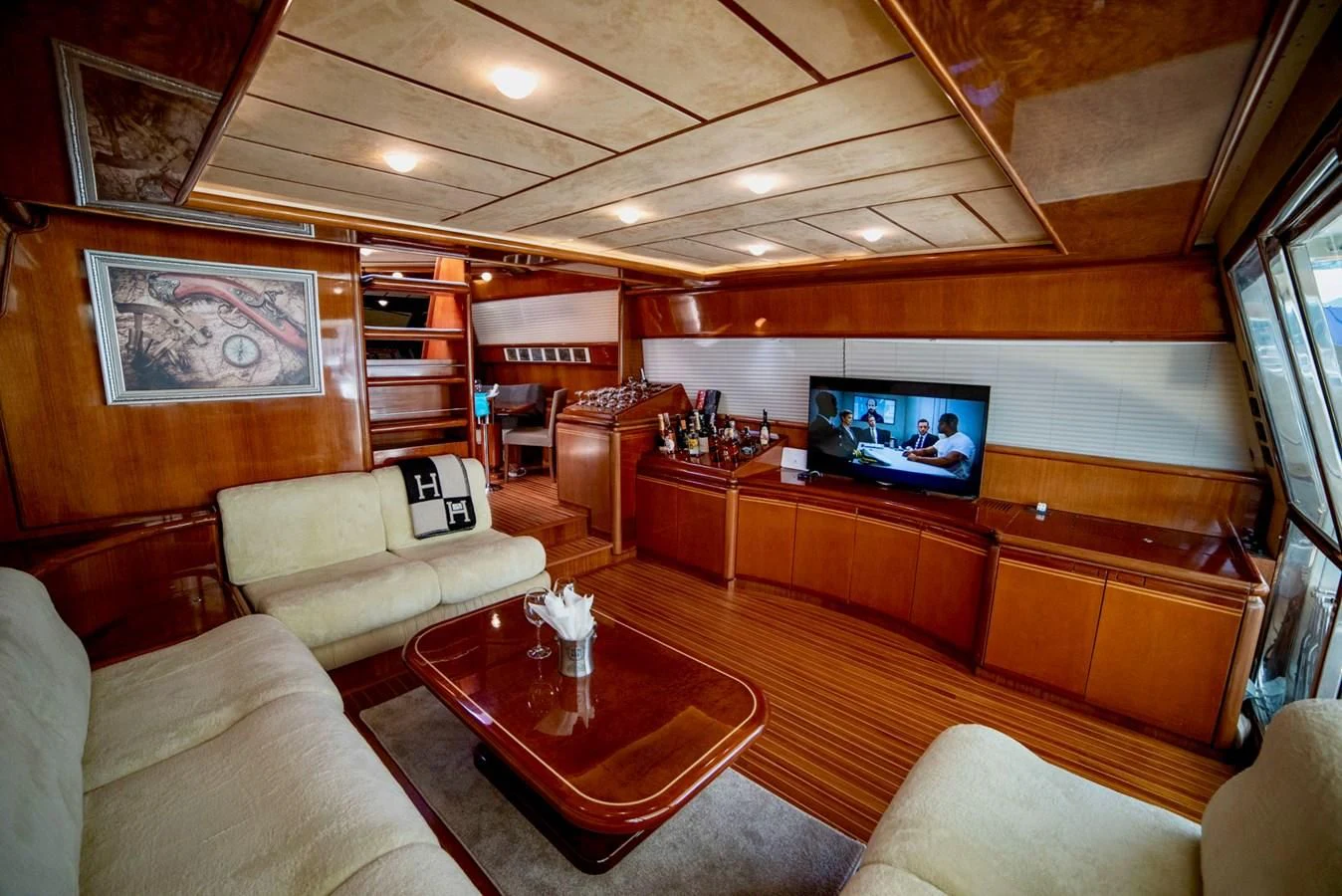 a living room with a tv and couches aboard FERRETTI Yacht for Sale