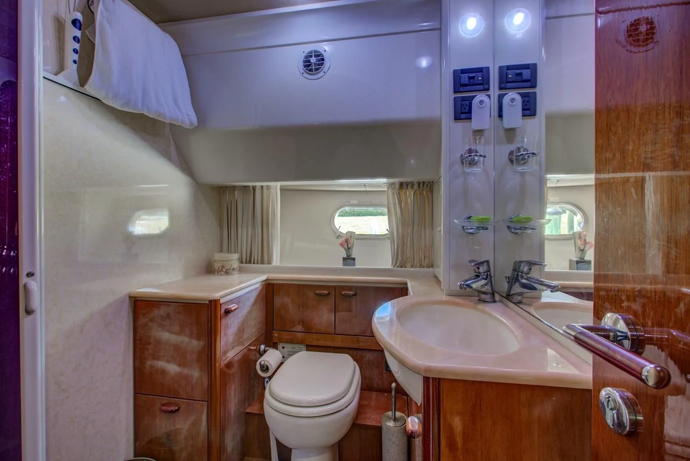 a bathroom with a sink toilet and a mirror aboard FERRETTI Yacht for Sale