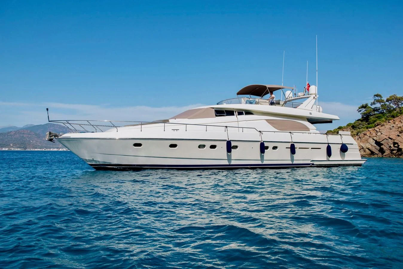 a white yacht in the water aboard FERRETTI Yacht for Sale