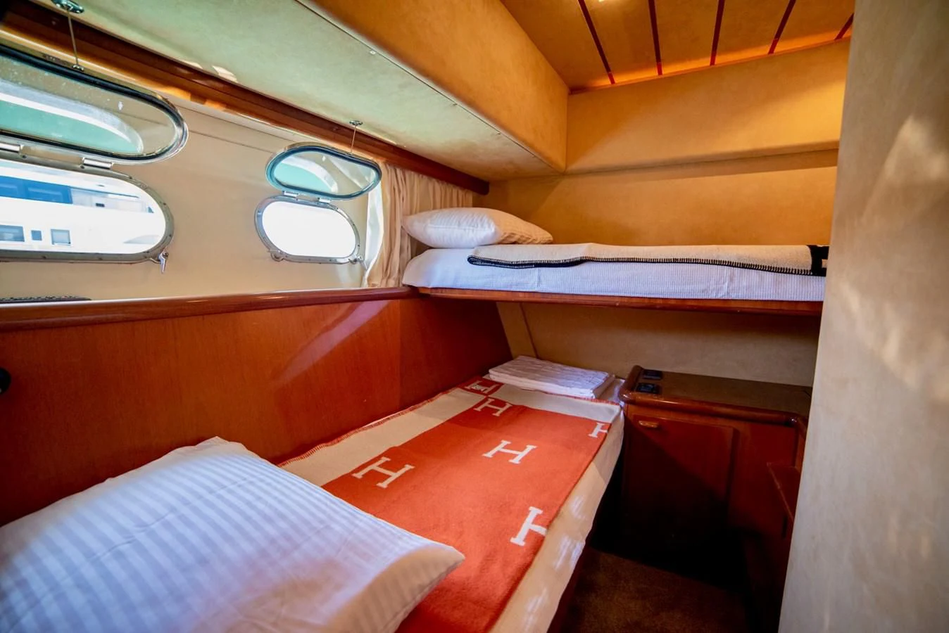 a room with a bed and a table aboard FERRETTI Yacht for Sale