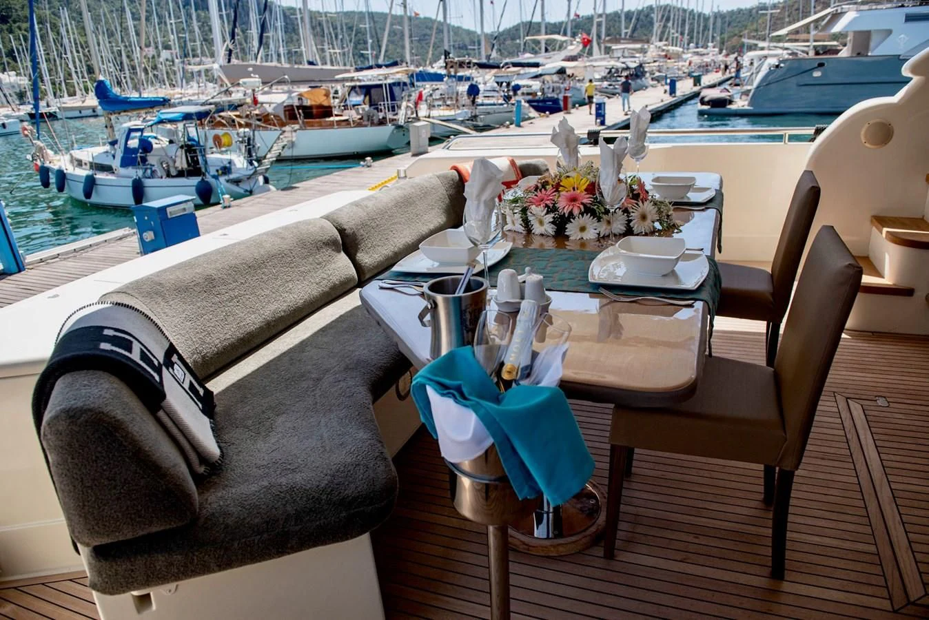 a table with chairs and a couch on it aboard FERRETTI Yacht for Sale