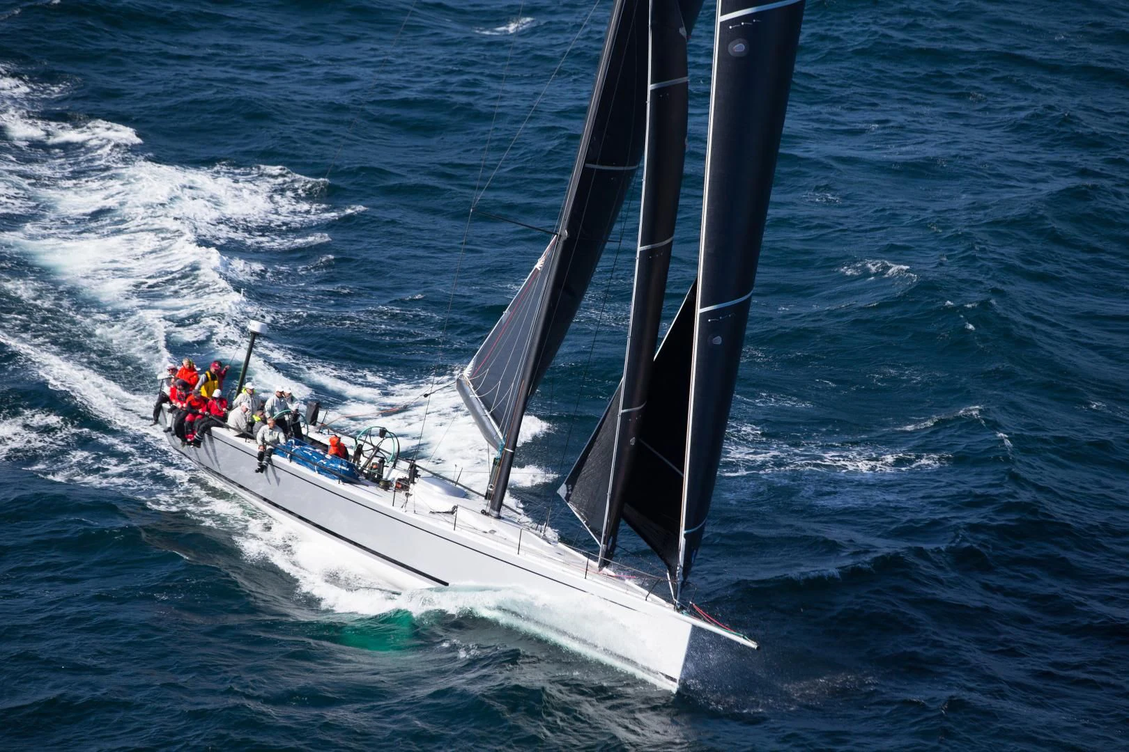 a group of people sailing on a boat in the ocean aboard PROSPECTOR Yacht for Sale