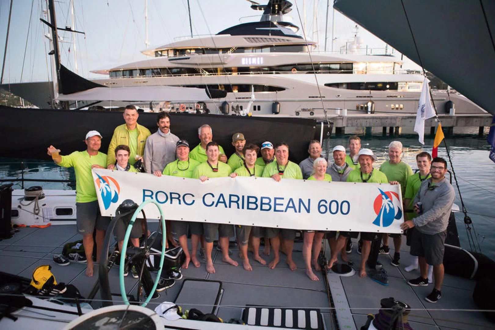 a group of people holding a sign aboard PROSPECTOR Yacht for Sale