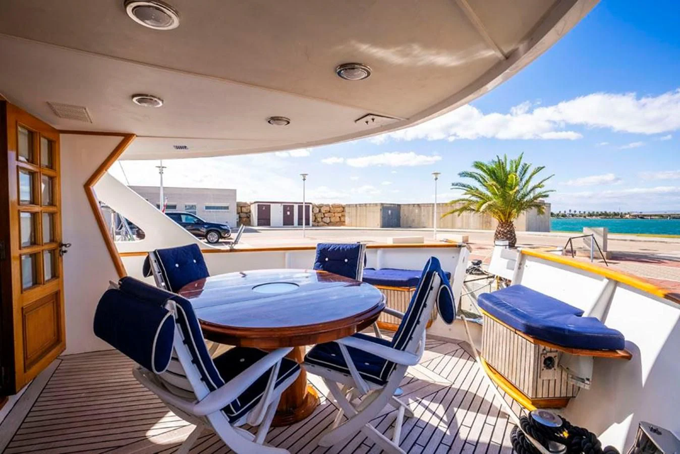 a room with a table chairs and a pool aboard MAXIME Yacht for Sale
