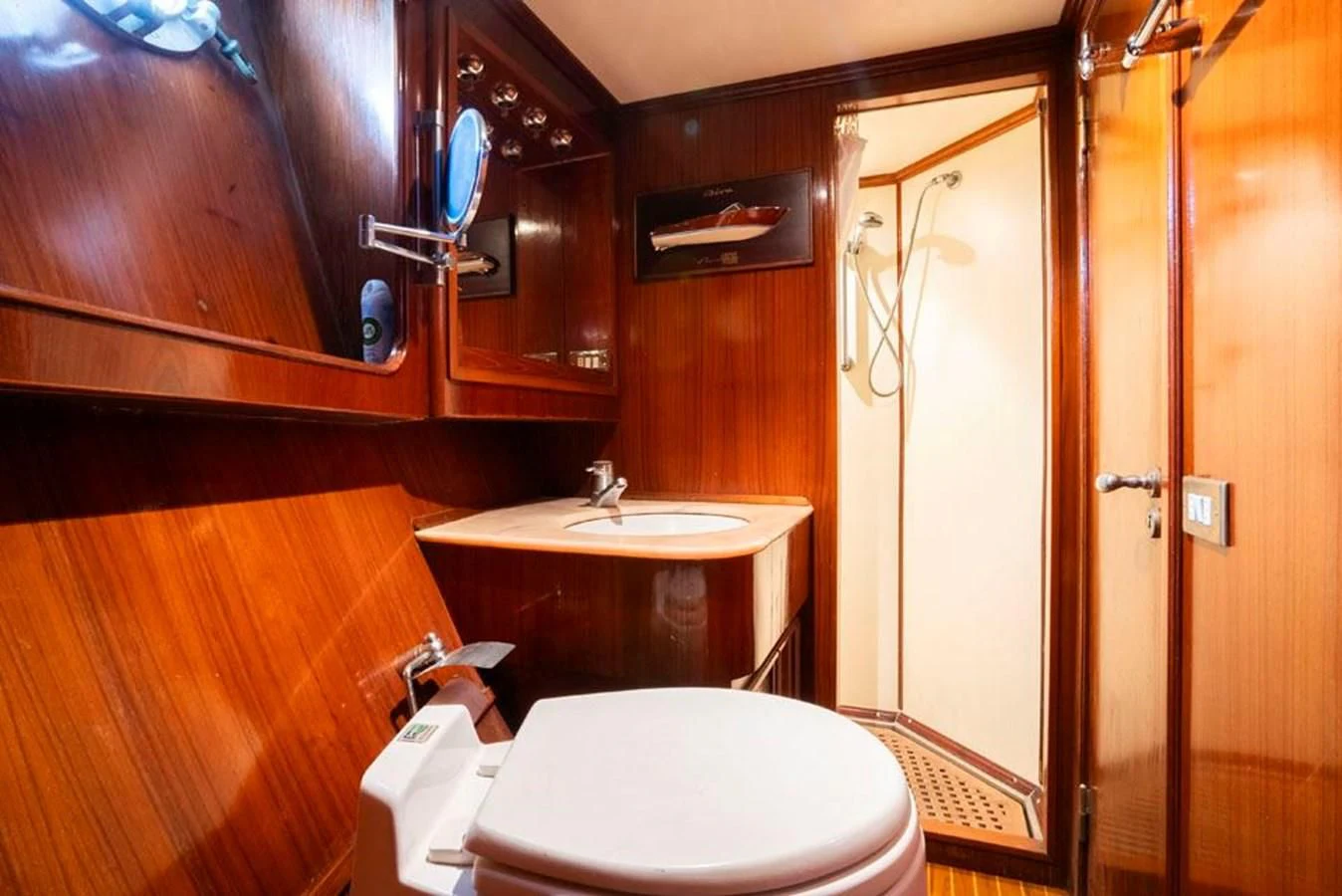 a bathroom with a toilet and a sink aboard MAXIME Yacht for Sale