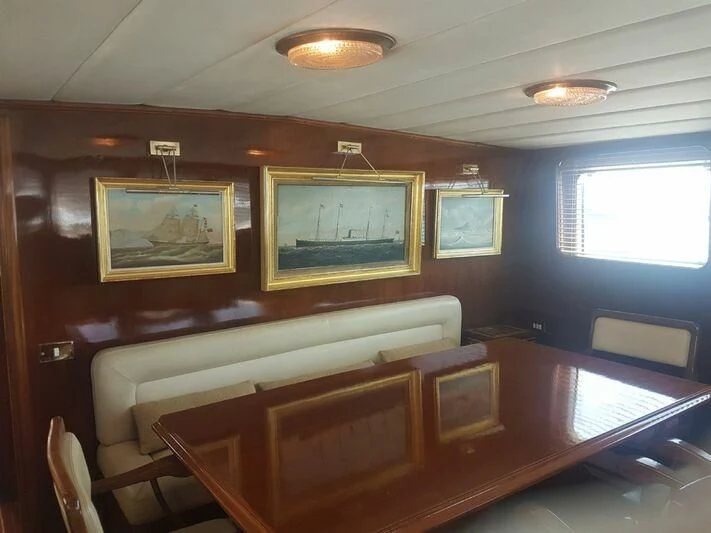 a room with a couch and a television on the wall aboard MAXIME Yacht for Sale