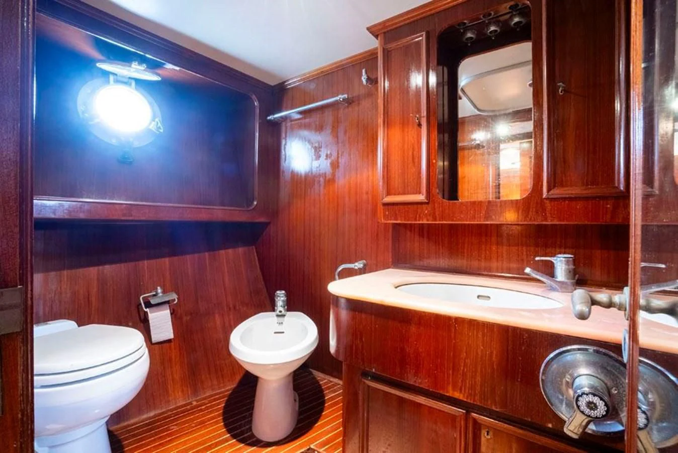 a bathroom with a sink toilet and a mirror aboard MAXIME Yacht for Sale