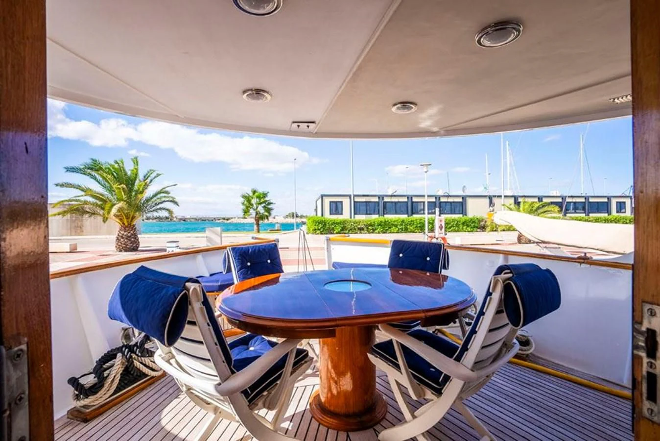 a table and chairs on a deck aboard MAXIME Yacht for Sale