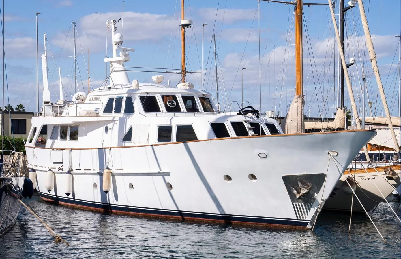 a boat docked in a harbor aboard MAXIME Yacht for Sale
