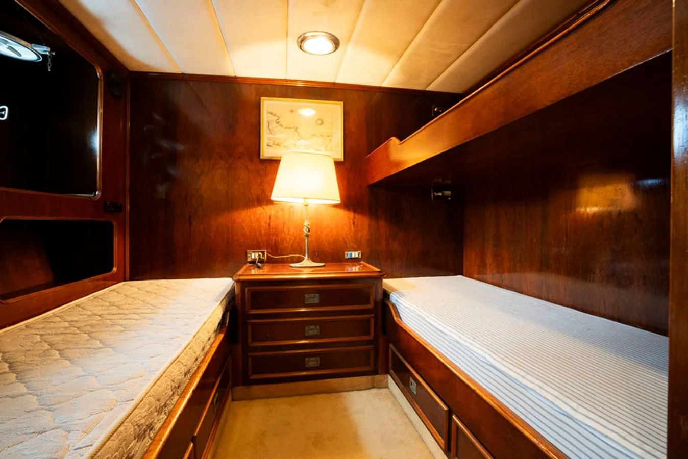 a room with a bed and a lamp aboard MAXIME Yacht for Sale