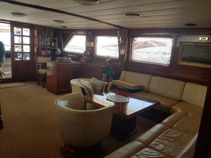 a living room with a couch and a coffee table aboard MAXIME Yacht for Sale