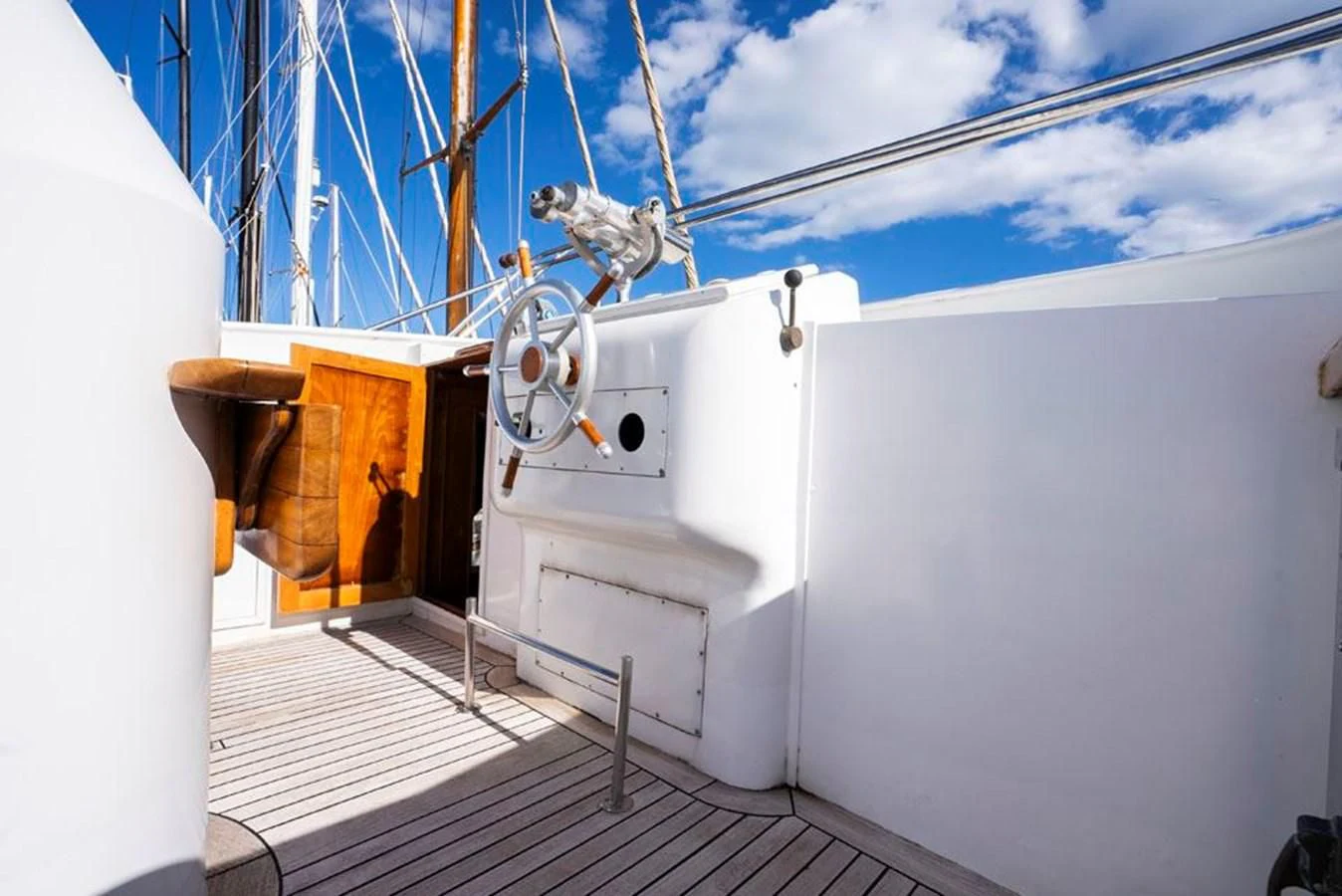 a white boat with a large wooden boat in the water aboard MAXIME Yacht for Sale