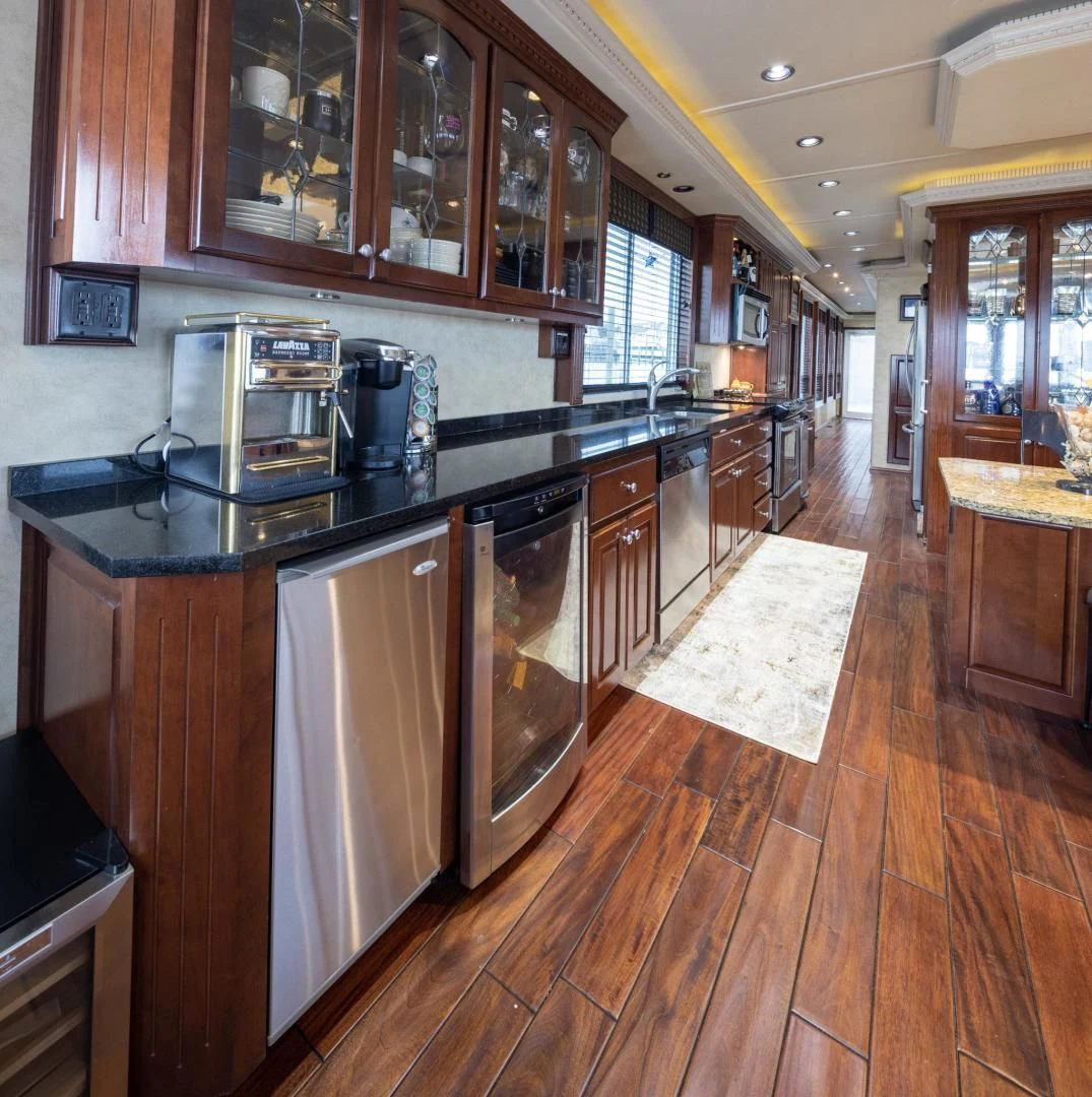 a kitchen with wooden cabinets aboard KNOT TIDE DOWN Yacht for Sale