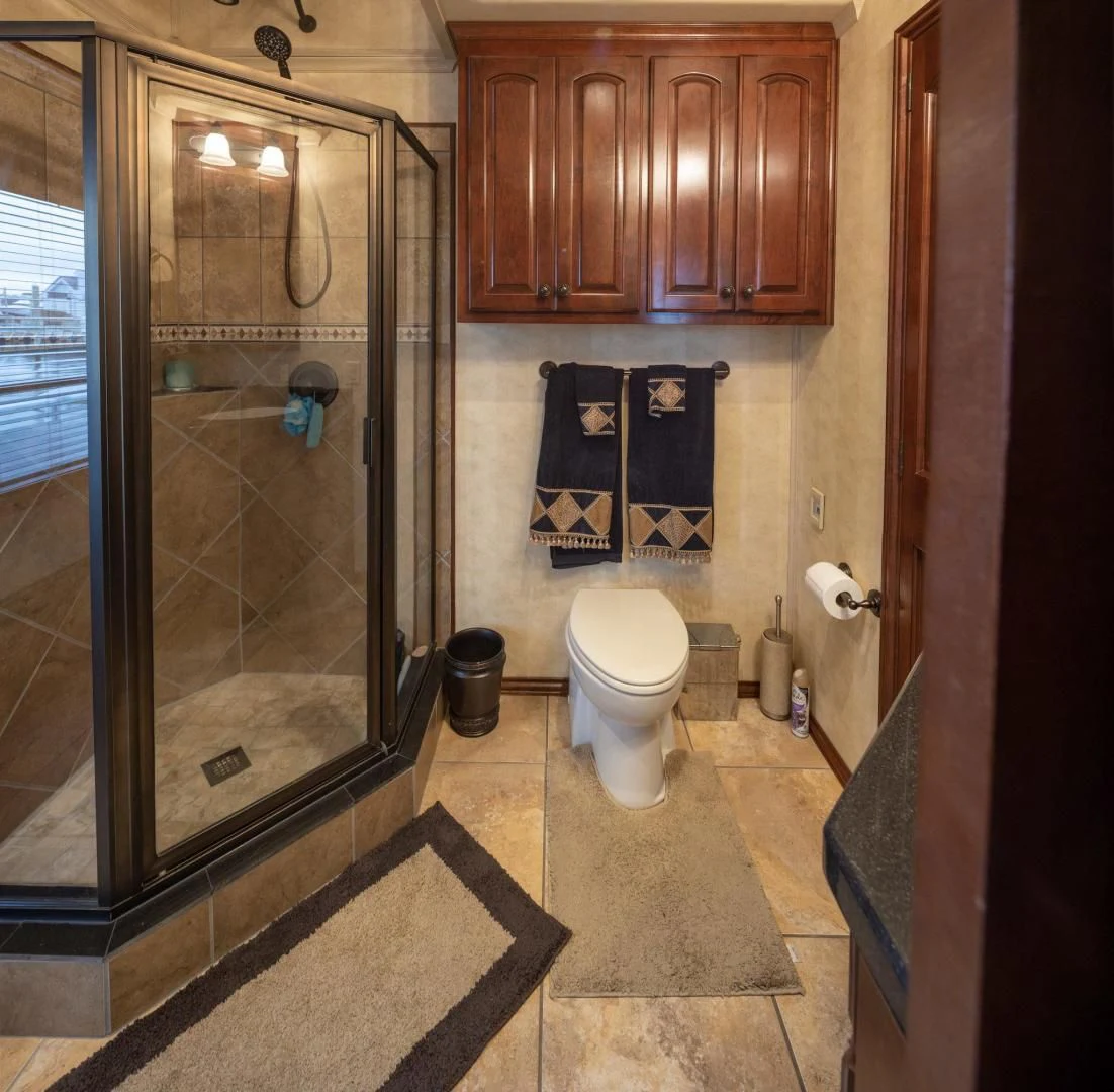 a bathroom with a glass shower aboard KNOT TIDE DOWN Yacht for Sale