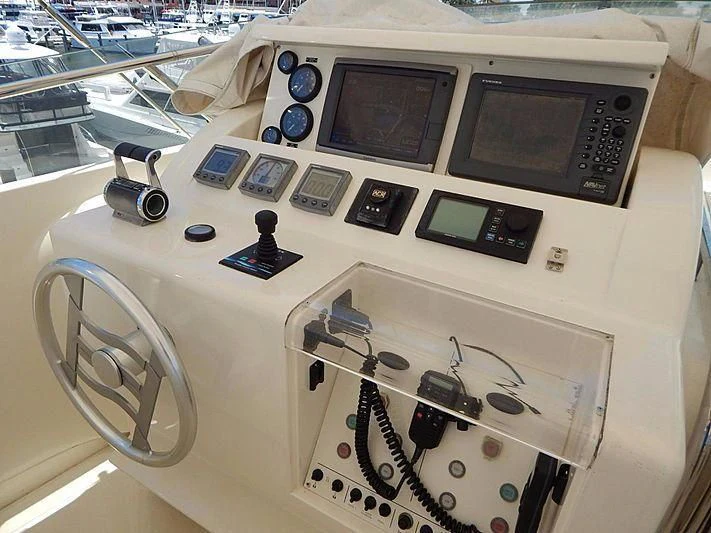 a white table with a fan and electronics on it aboard NOAH'S Yacht for Sale