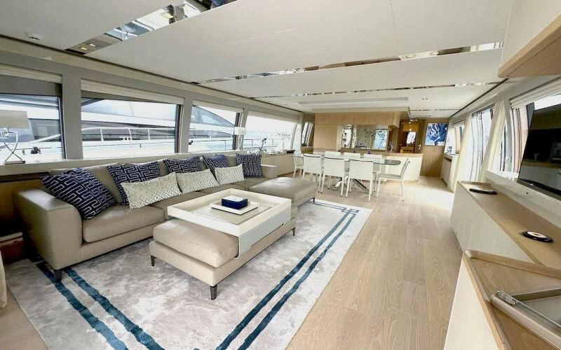 a living room with a couch and a table aboard BLUE DODO Yacht for Sale