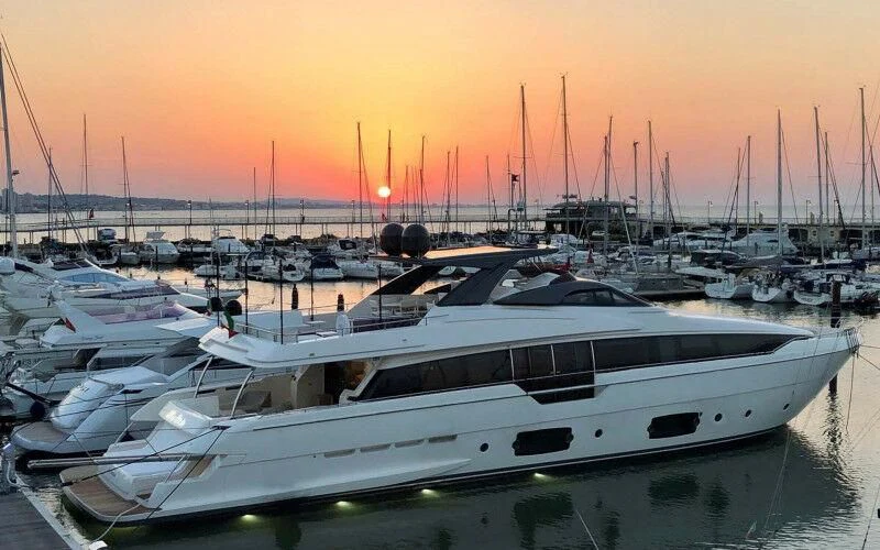 a group of boats sit in a harbor aboard BLUE DODO Yacht for Sale