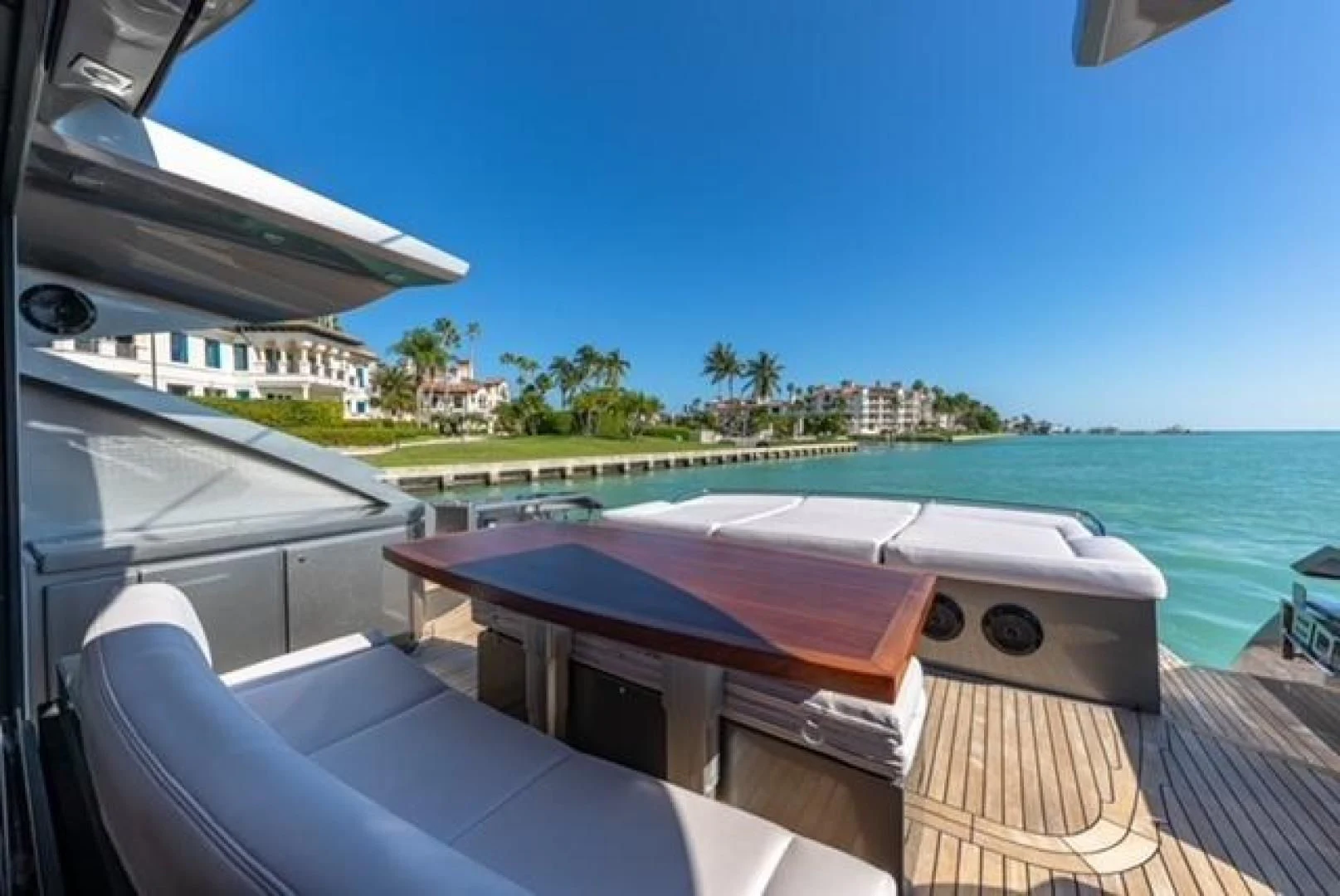 a deck with a pool and a building in the background aboard RAW 2-HP Yacht for Sale