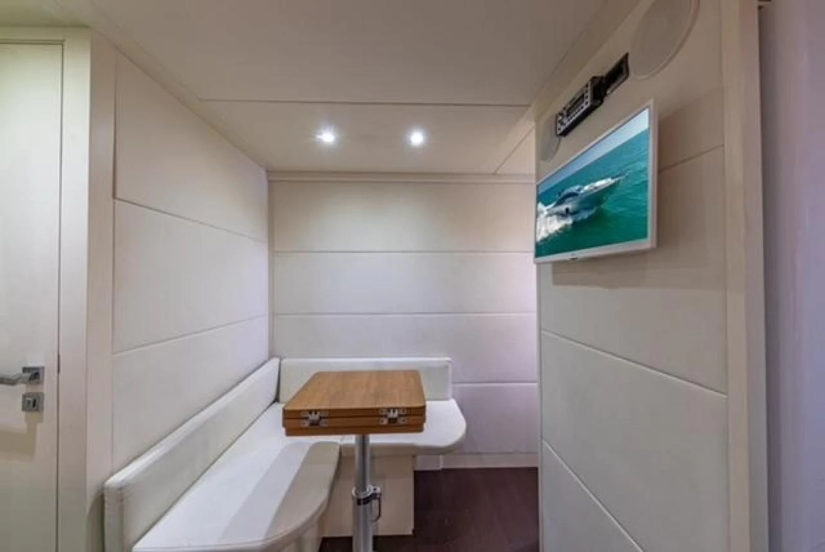 a small bathroom with a small television on the wall aboard RAW 2-HP Yacht for Sale