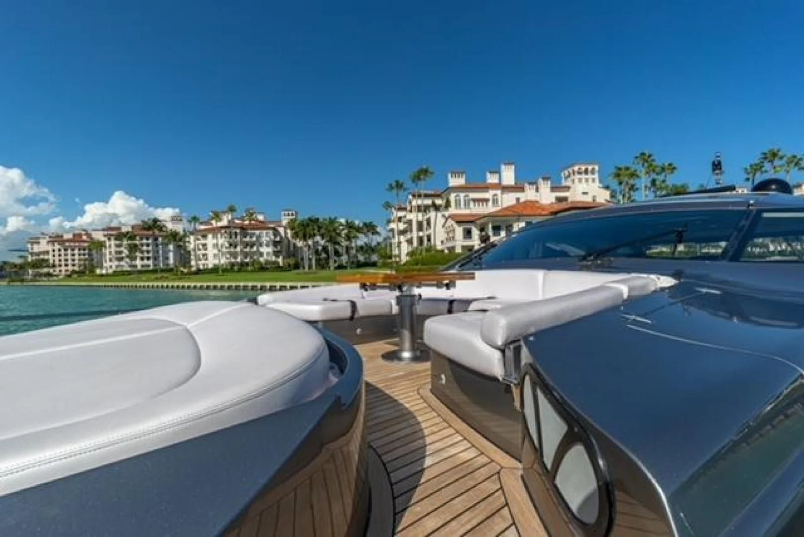 a deck with a pool and buildings in the background aboard RAW 2-HP Yacht for Sale