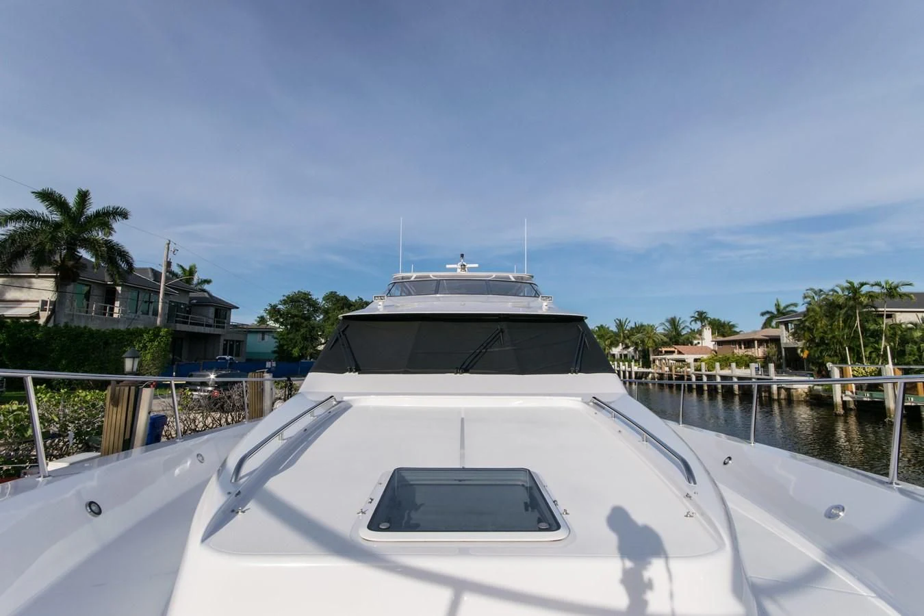 a white yacht in a harbor aboard LIFE'S A JOURNEY Yacht for Sale