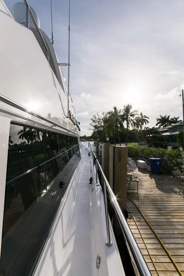 a deck with a railing and a railing with a building and trees in the background aboard LIFE'S A JOURNEY Yacht for Sale