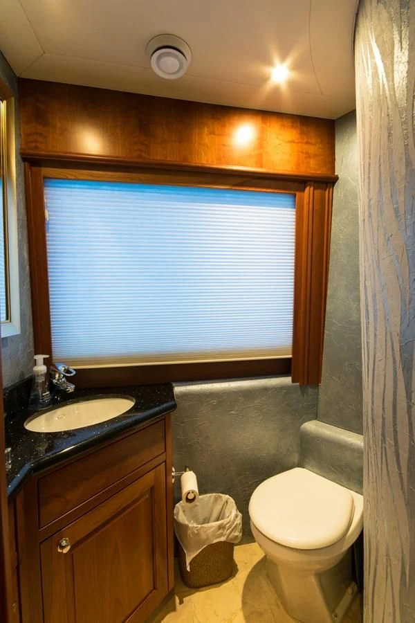 a bathroom with a toilet and a sink aboard LIFE'S A JOURNEY Yacht for Sale