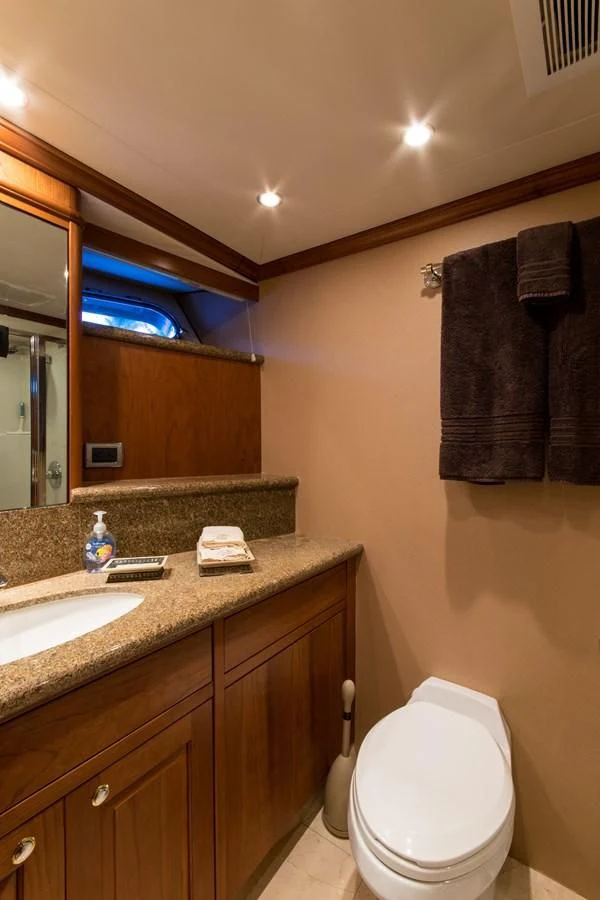 a bathroom with a toilet and a sink aboard LIFE'S A JOURNEY Yacht for Sale