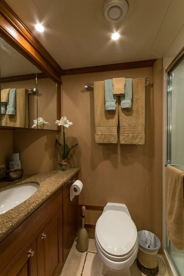 a bathroom with a toilet and a sink aboard LIFE'S A JOURNEY Yacht for Sale