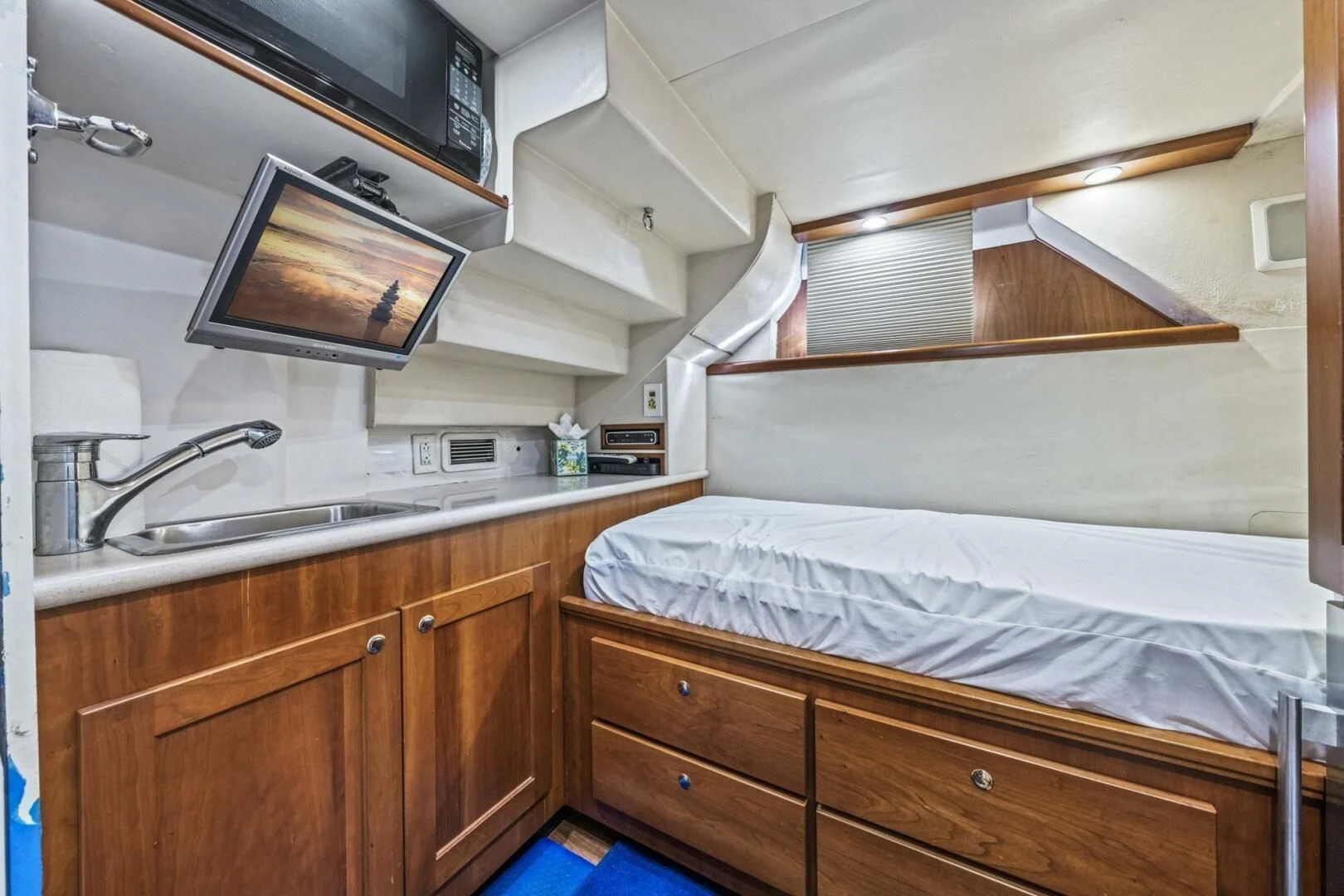 a bedroom with a bed and a television aboard LIFE'S A JOURNEY Yacht for Sale